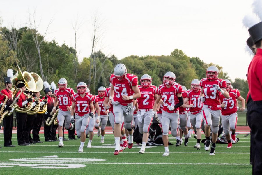 The football team takes the field during pregame on the September 22nd Homecoming football game.
