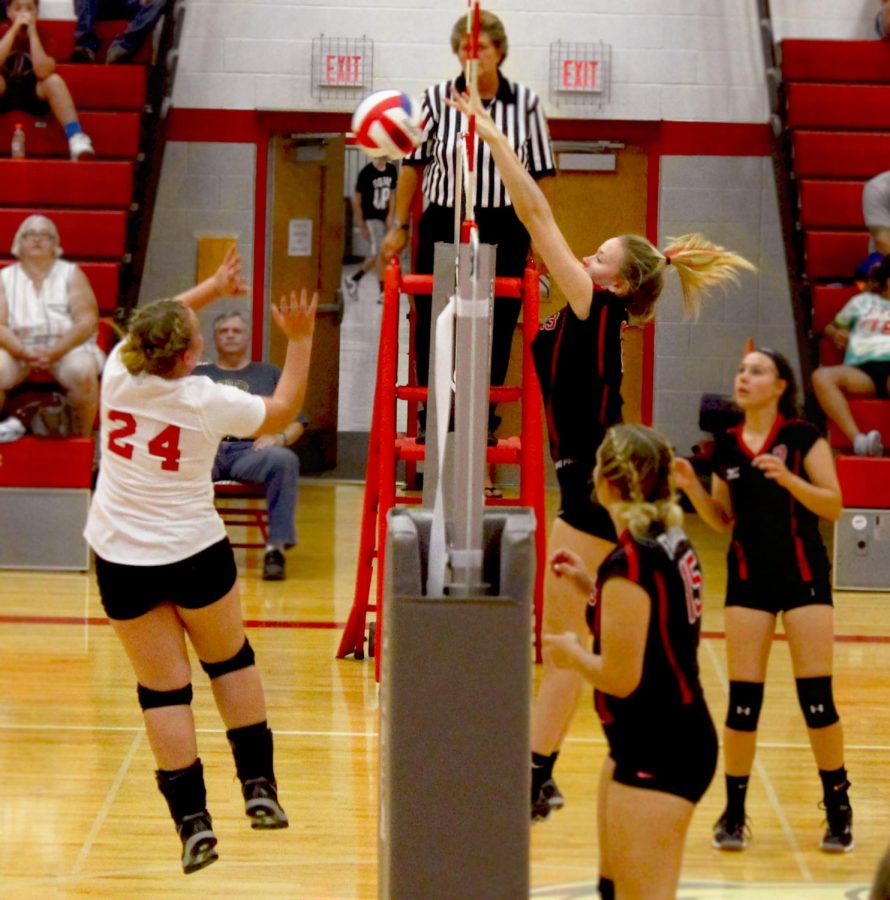 Junior Morgan Malinski jumps up from the side to block the opposing team from scoring.