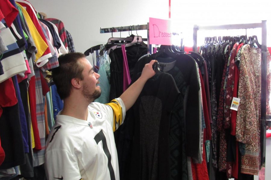 Senior Dalton Walker helps out in organizing the Rocket Closet.  The clothes are free for any students who need them.
