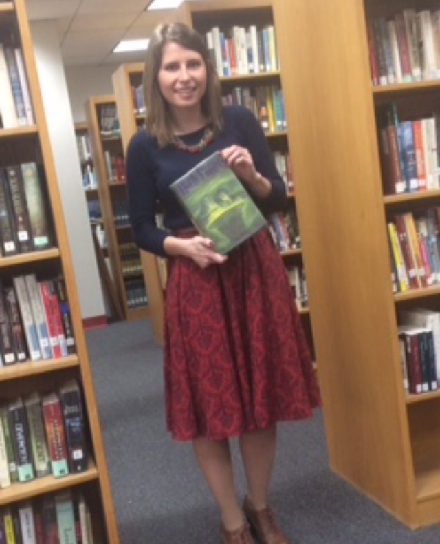 Ms. Hegarty holds Harry Potter and the Half-Blood prince, which is a book from one of her favorite series.