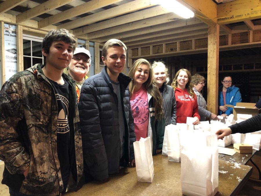 Light it Up! Nate Gill, Garrett Galcik , Mekenzie Pfluger, Ashley Rodgers, and Morgan Malinski make luminaries for the Prospect Rotary Club. Photo by Mackenzie McMillin