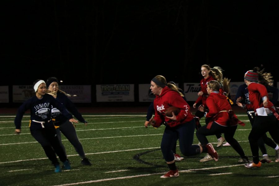 Head to head. The seniors attempt to drive the ball up the field, while the juniors try to thwart their plans.  The Powderpuff game occurred on November 8th. Photo by Devin Eakin.