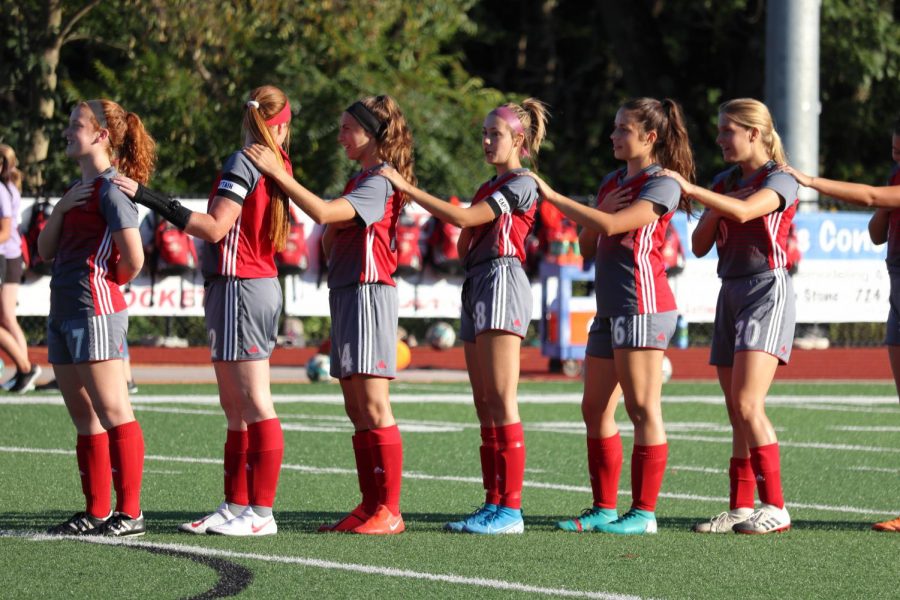 The girls soccer team links together, an annual tradition at the home game versus Grove City on September 6, 2019.
