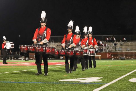 Members of the drumline, including senior Greg Pritts and junior Christian Shaffer, play the tenors during the Grove City College Marching Band Invitational on October 12.