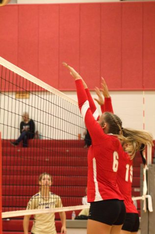 Reagan Duffy (22) jumps to block a ball coming over the net.