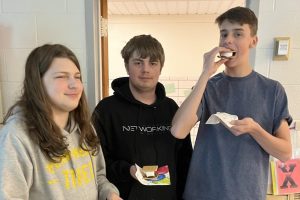 Bradyn Trinkley (24), Devan Kriess (24), Phillip Sybert (24) eat smores during CAMP day on April 29 while also completing career-related activities using the Smart Futures software.